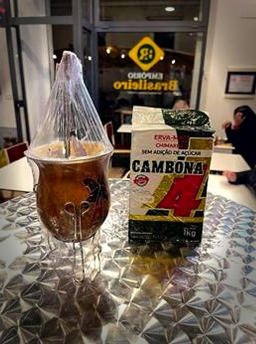 Un mate ghiacciato davanti alle confezioni di erva mate in vetrina